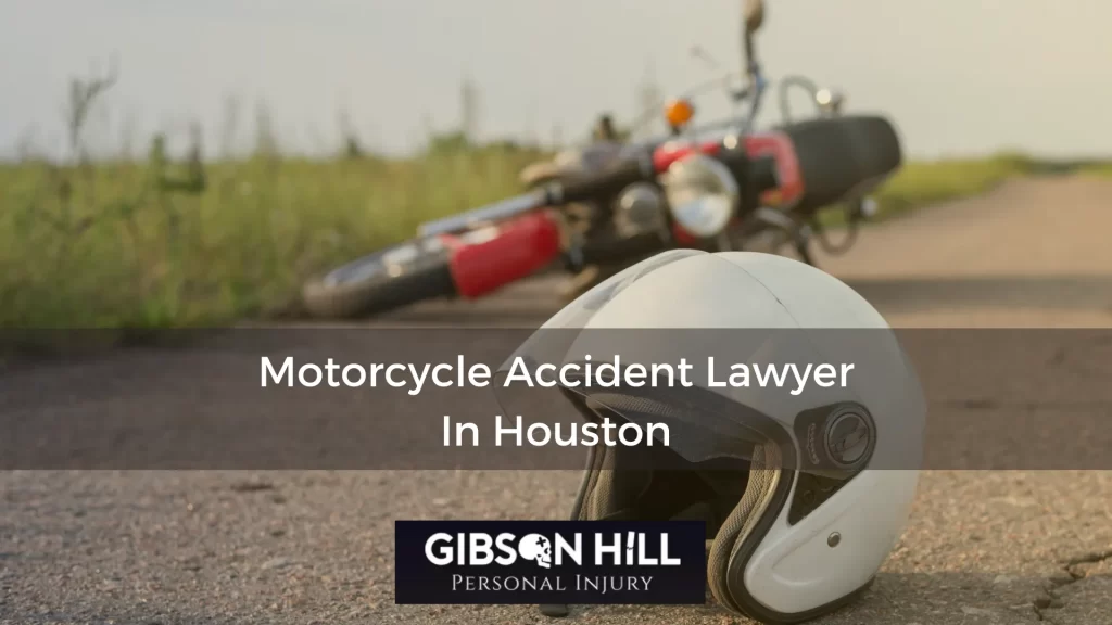 Motorcycle on its side in the background, white helmet in the foreground on asphalt with the superimposed words: Motorcycle Accident Lawyer in Houston.